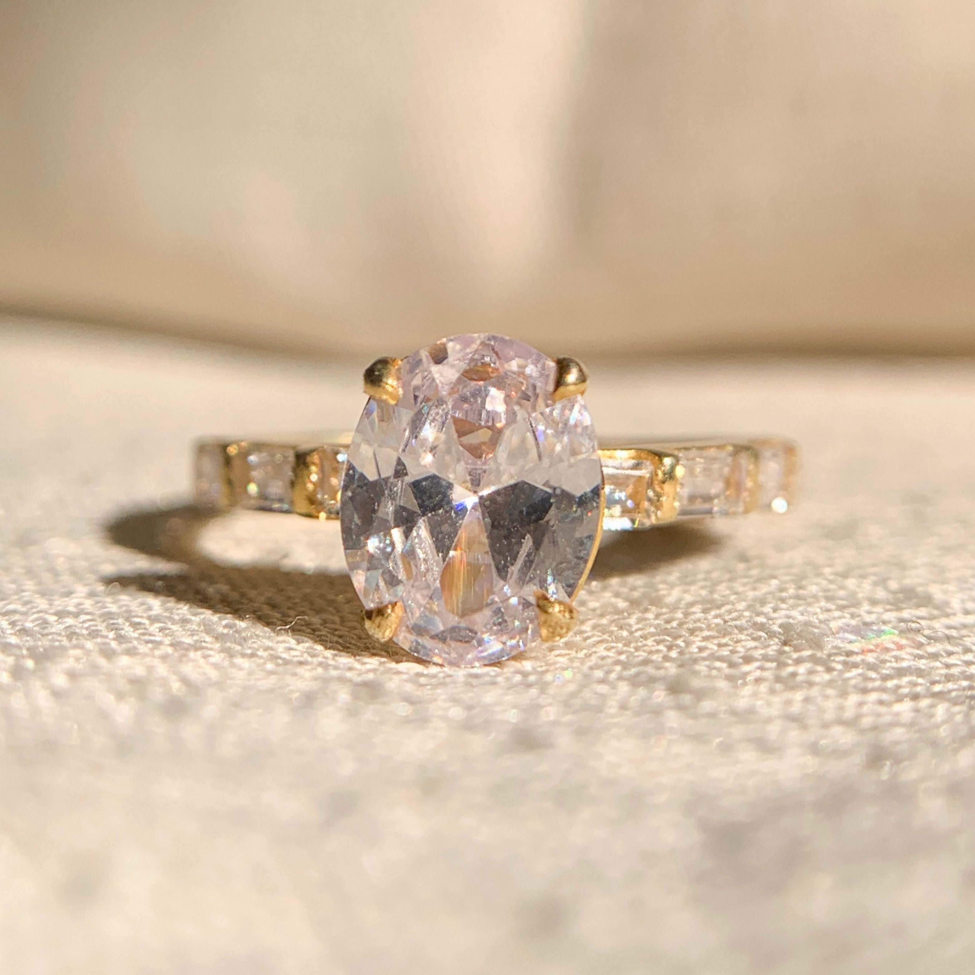 Oval cut moissanite engagement ring with sparkling side stones in white gold